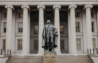 Statue in front of a U.S. government building.