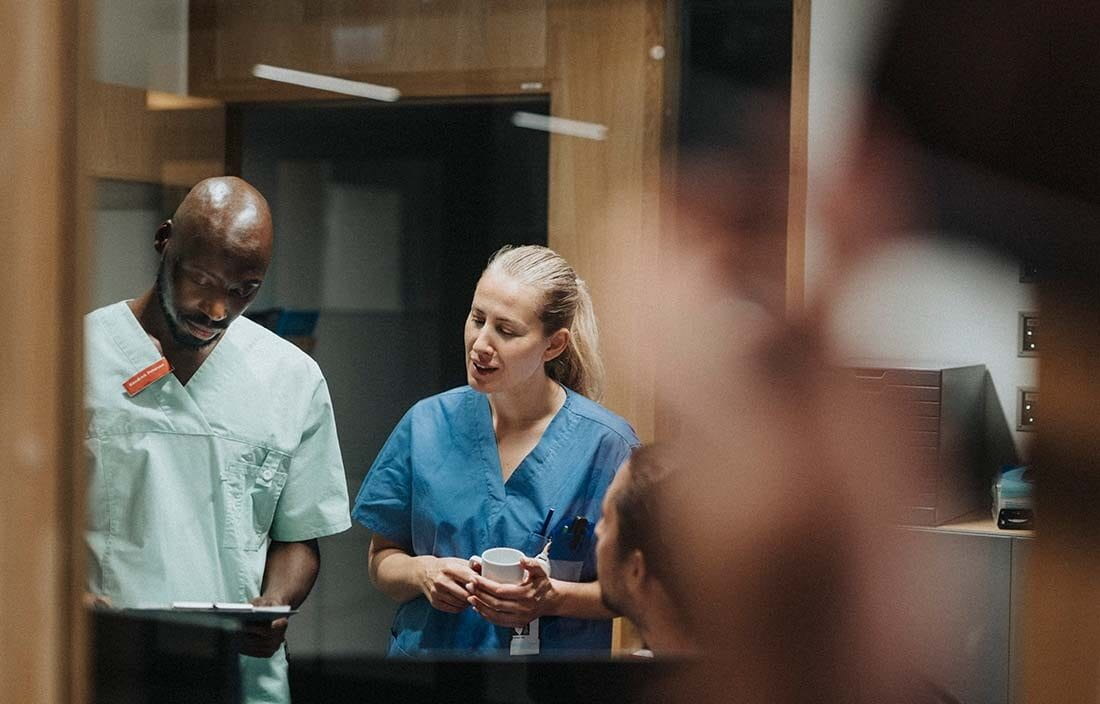 Two healthcare professionals looking at a medical chart