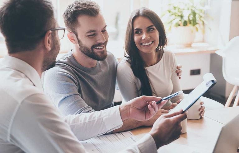 Spouses discussing a SLAT with their financial advisor.