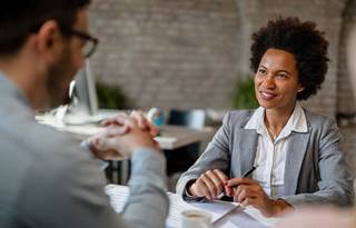Business professionals talking about federal financial assistance for grants.