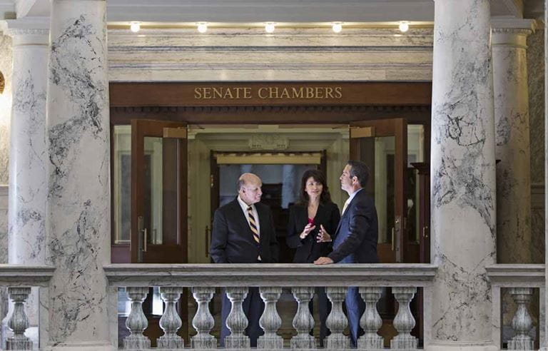 Business professionals in suits standing in a court house environment