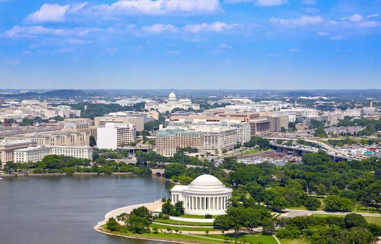 Aerial view of city by a waterfront.