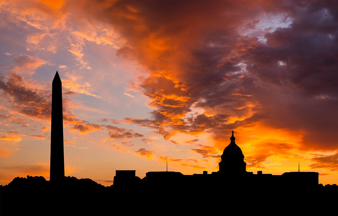 Washington D.C. skyline against a cloudy sunset.