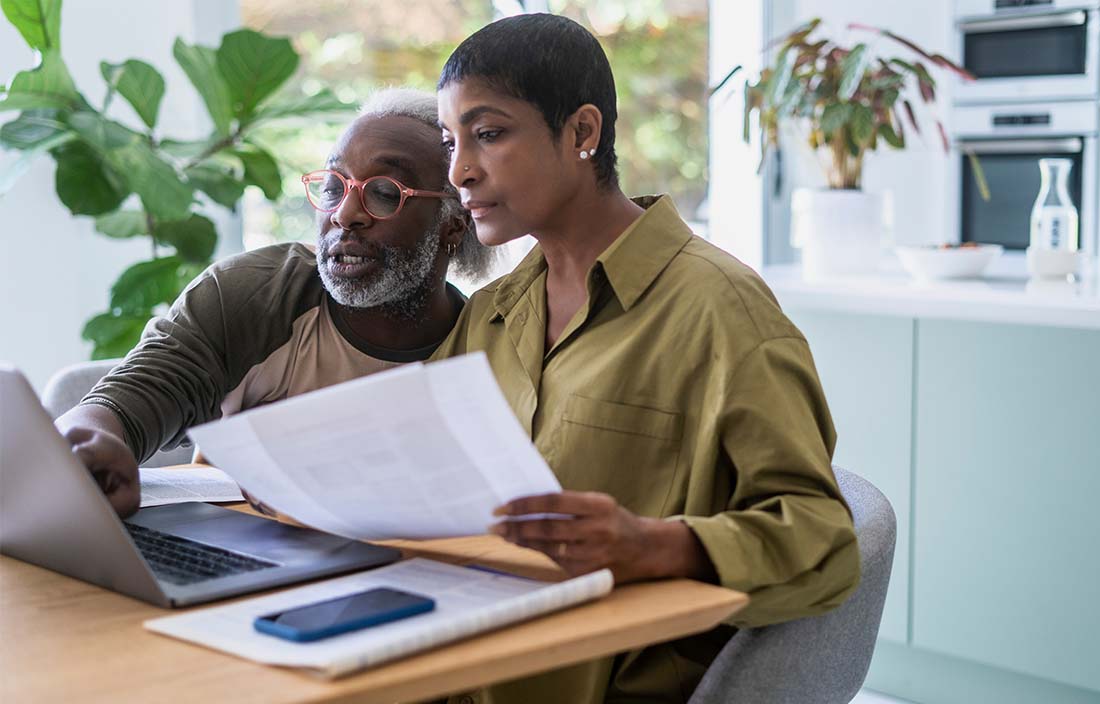 Wealthy couple reviewing financial strategies for the new year.