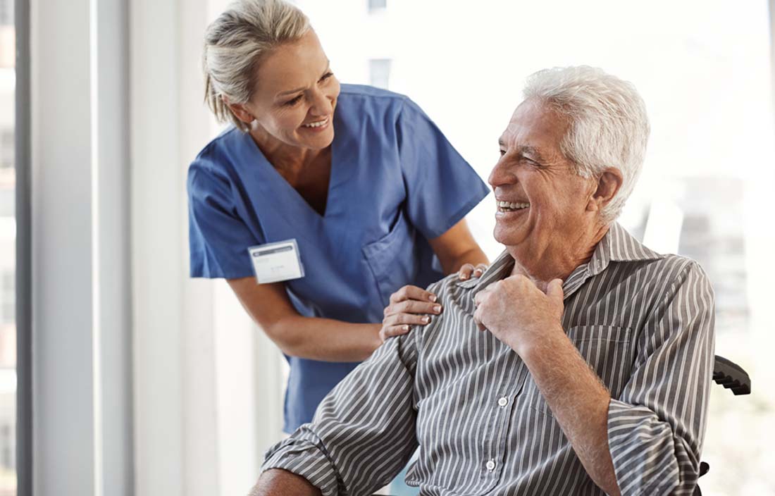 Nurse talking to their senior patient.