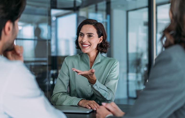 A group of professionals engaged in a discussion in an office.