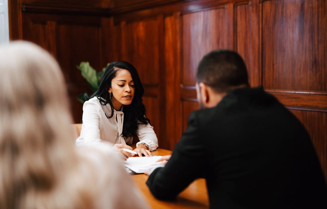 Two business professionals sitting at a table discussing share based payments