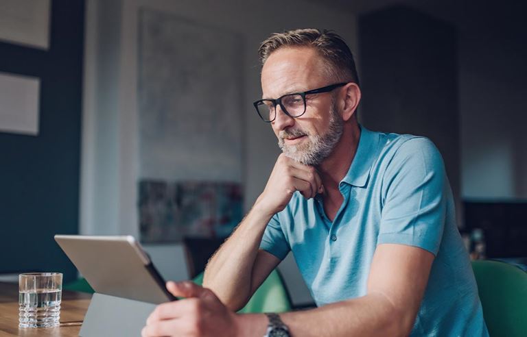 Wealthy individual reading about how tobacco use affects life insurance.