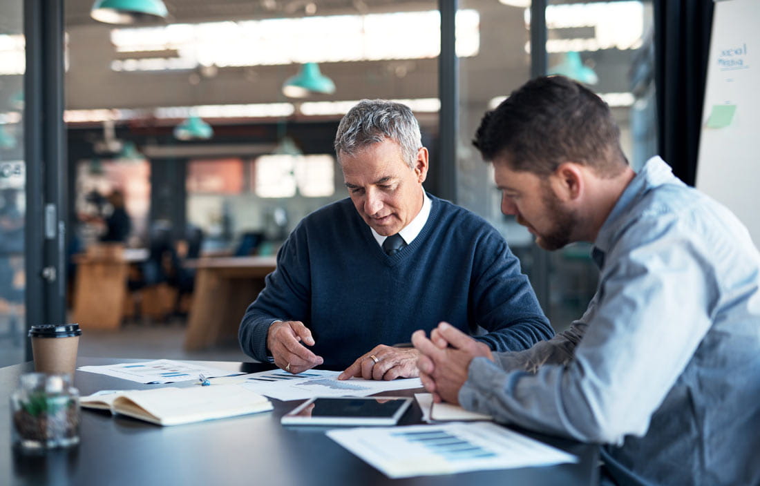 Two business professionals discussing uniform guidance with one another