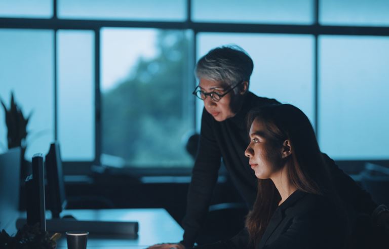 Two people analyzing transactions.