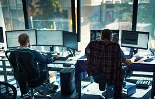 Software developers working on computers at the office.
