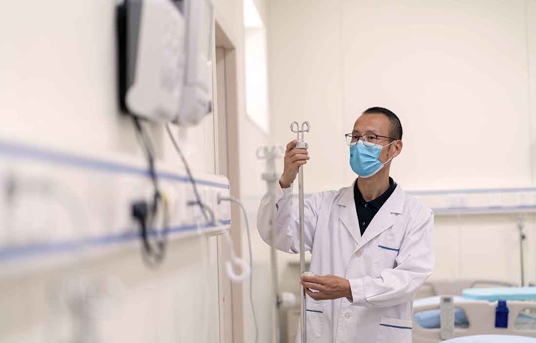 Doctor with a face mask in a hospital.