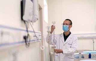 Doctor with a face mask in a hospital.