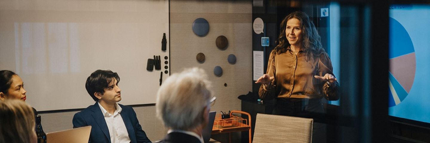 Business professionals talking about data analytics in a modern conference room.