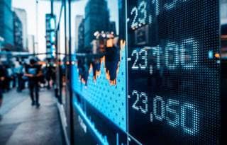 Close-up of trade numbers digital display on a busy city street side-walk