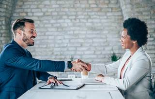 Business professionals shaking hands.