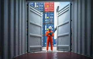 Factory worker inspecting shipments.