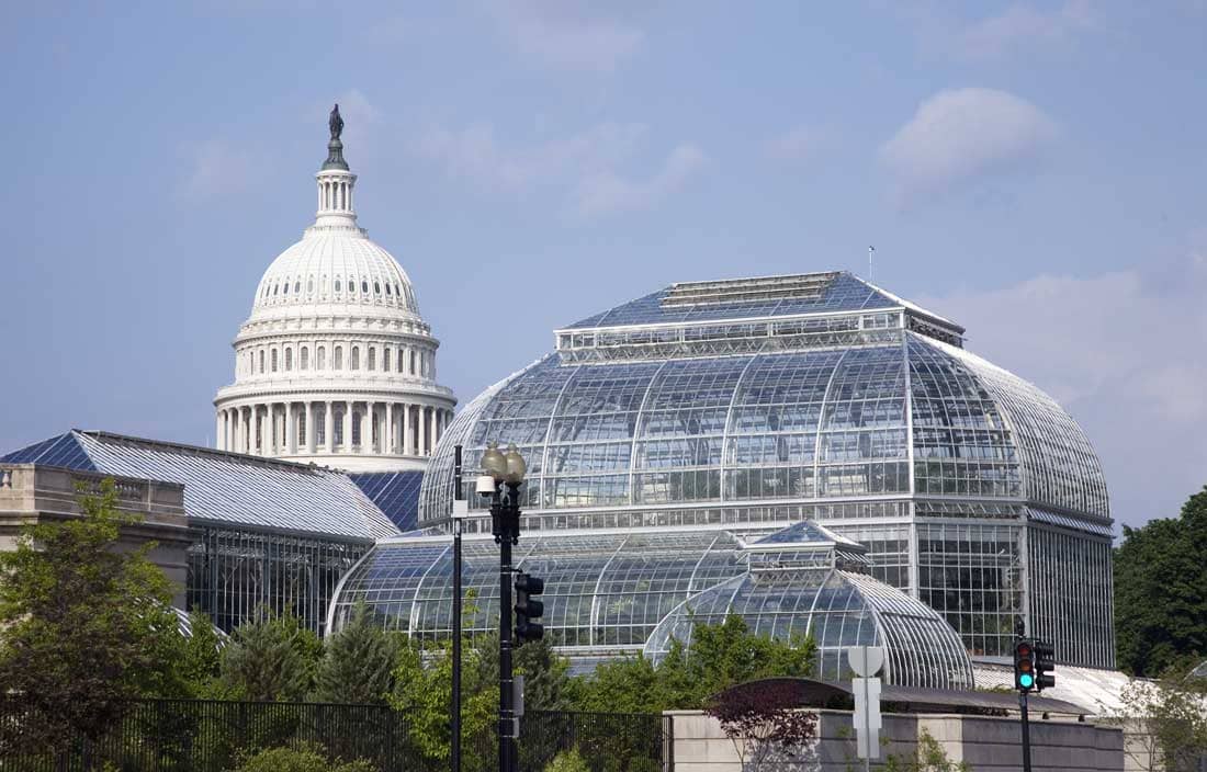 Government building with greenhouse during the day.