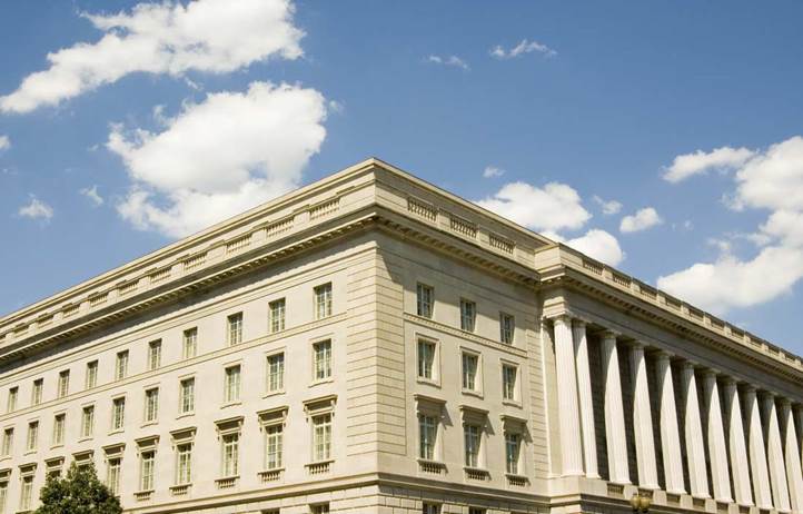 Close up photo of the corner of a four-story brick building