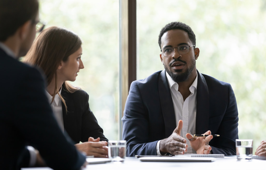 Business professionals sitting at a modern conference room table