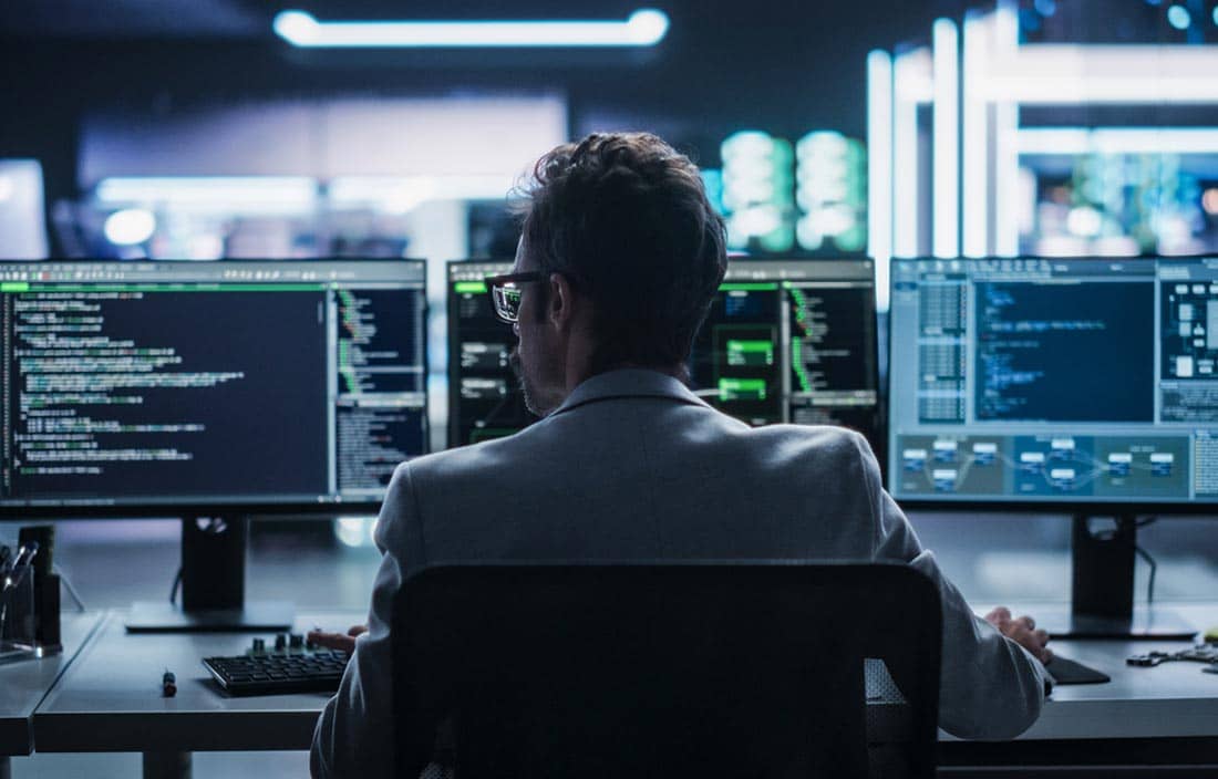 Cybersecurity professional working at their computer.