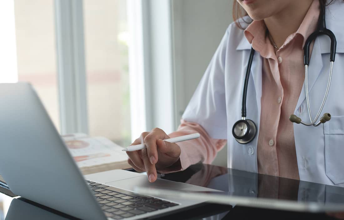 Medical professional on their computer.