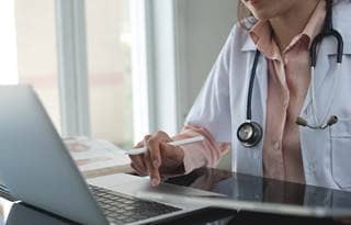 Medical professional on their computer.