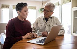 Couple looking at their laptop.
