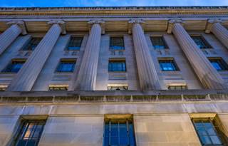 Close up of government building at night.