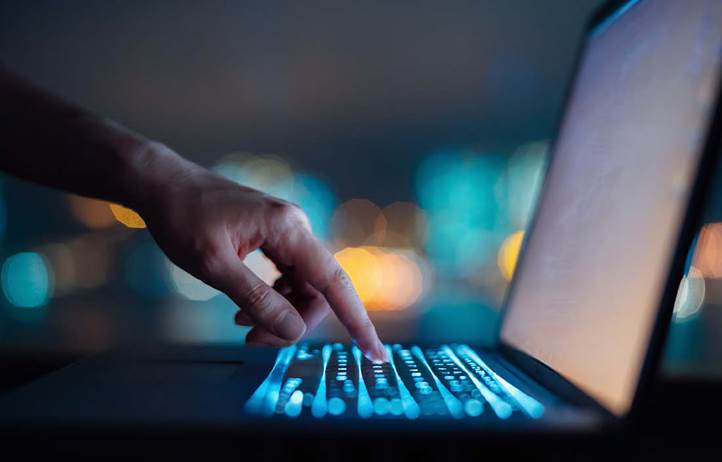 Person typing on a laptop.