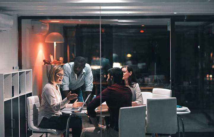 Group of audit professionals meeting in a conference room.