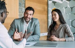 Couple talking to their financial advisor.