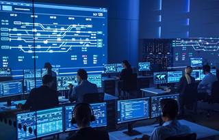 Cybersecurity professionals in a tech center.