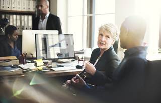 Business professionals discussing worker classification.