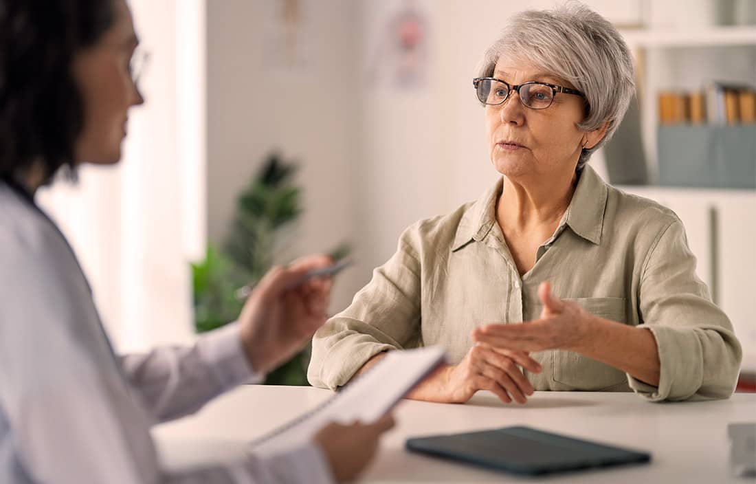 Catholic nun discussing potential Medicaid cuts with doctor.