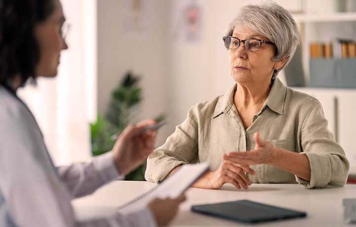 Catholic nun discussing potential Medicaid cuts with doctor.