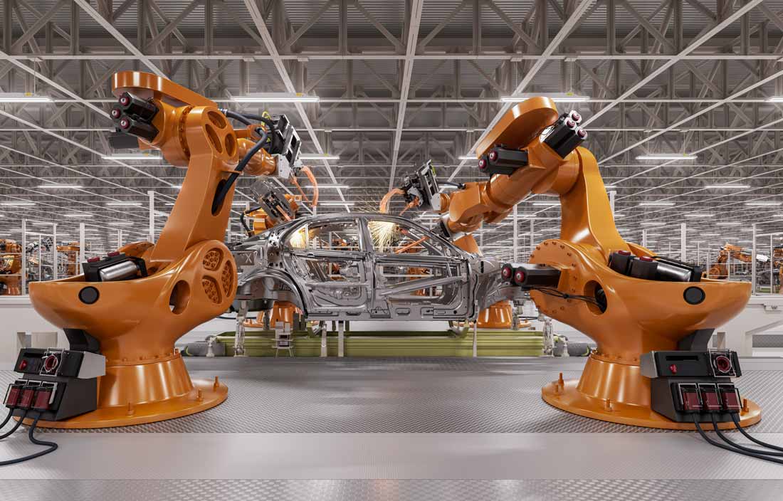 Two machines manufacturing an automobile in a factory.