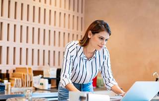 Service industry professional learning about key OBBB insights on their laptop.