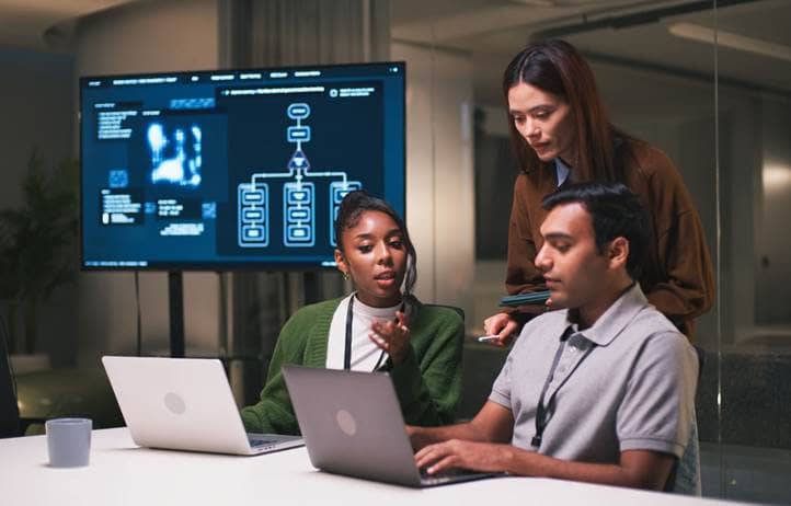 Technology professionals at work discussing how the NAIC AI model bulletin is evolving.