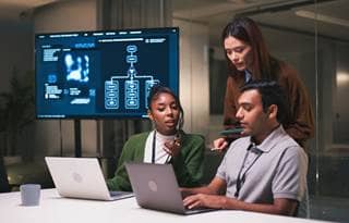 Technology professionals at work discussing how the NAIC AI model bulletin is evolving.