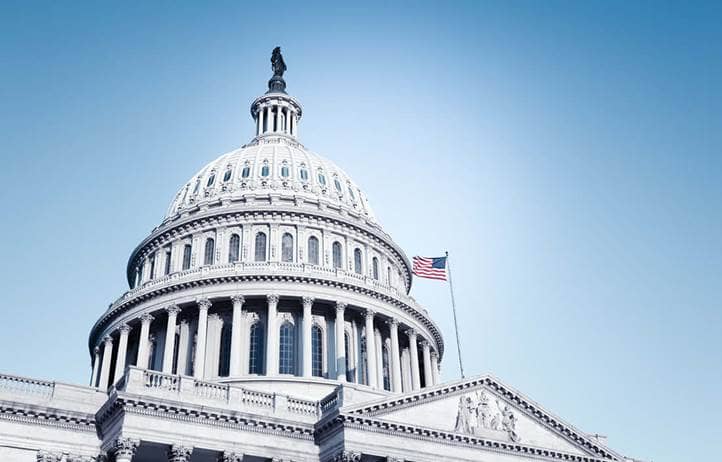 U.S. Capitol building against a blue sky.