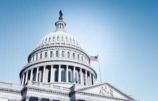 U.S. Capitol building against a blue sky.