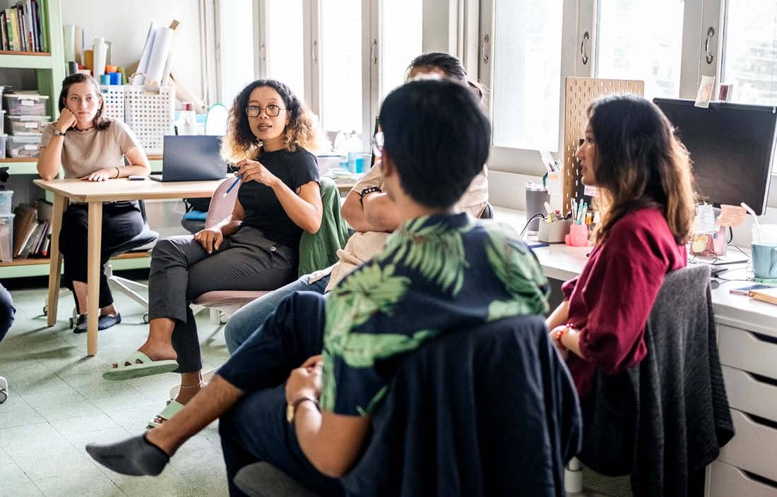 Group of nonprofit professionals discussing cost-saving trends.