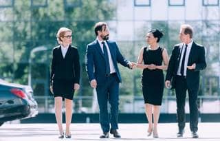Group of business professionals walking and talking after a meeting.