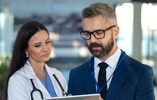 Doctor and healthcare professional talking to each other.