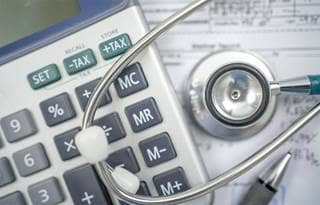 Close-up photo of a stethoscope and calculator