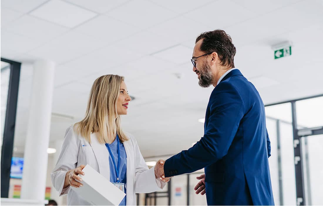 Doctor talking to a business professional.