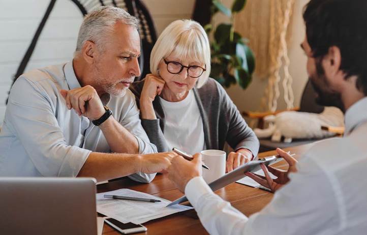 Elderly couple meeting with their financial advisor