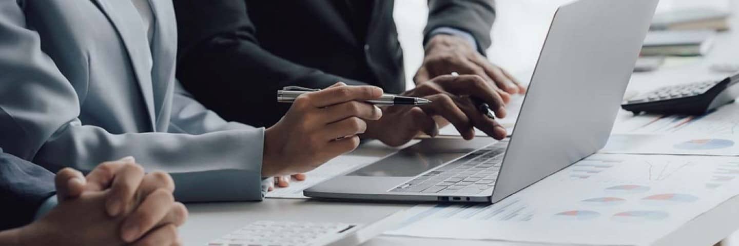 Business professionals typing on their laptop.