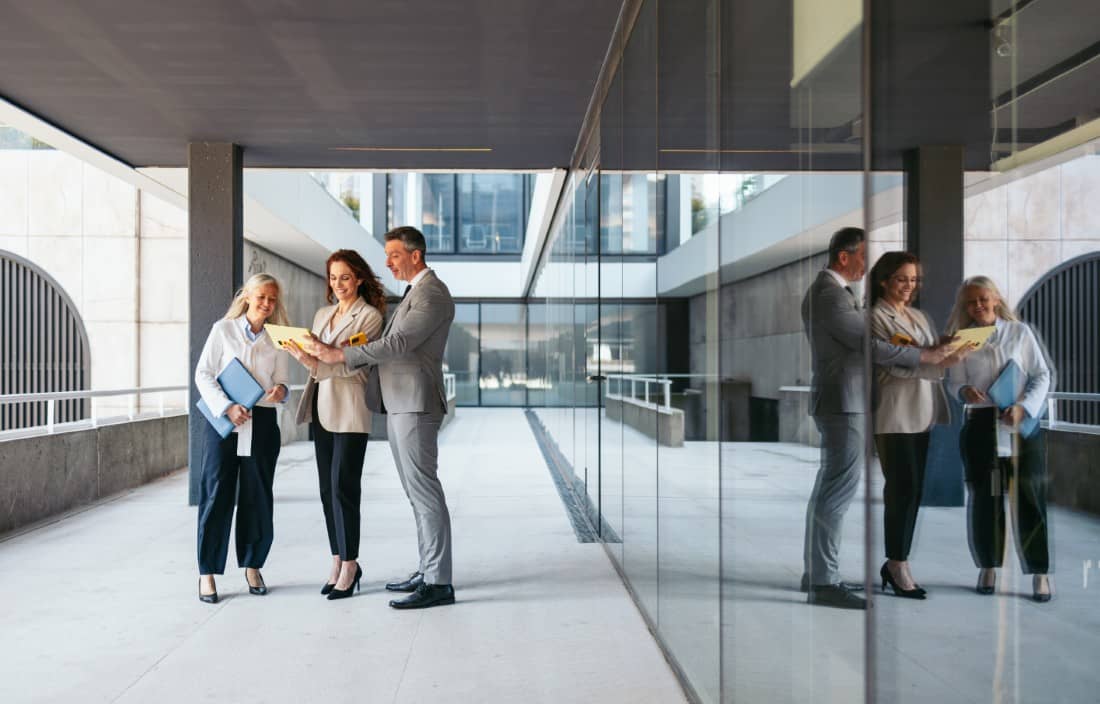 Business professionals talking in a modern office building.